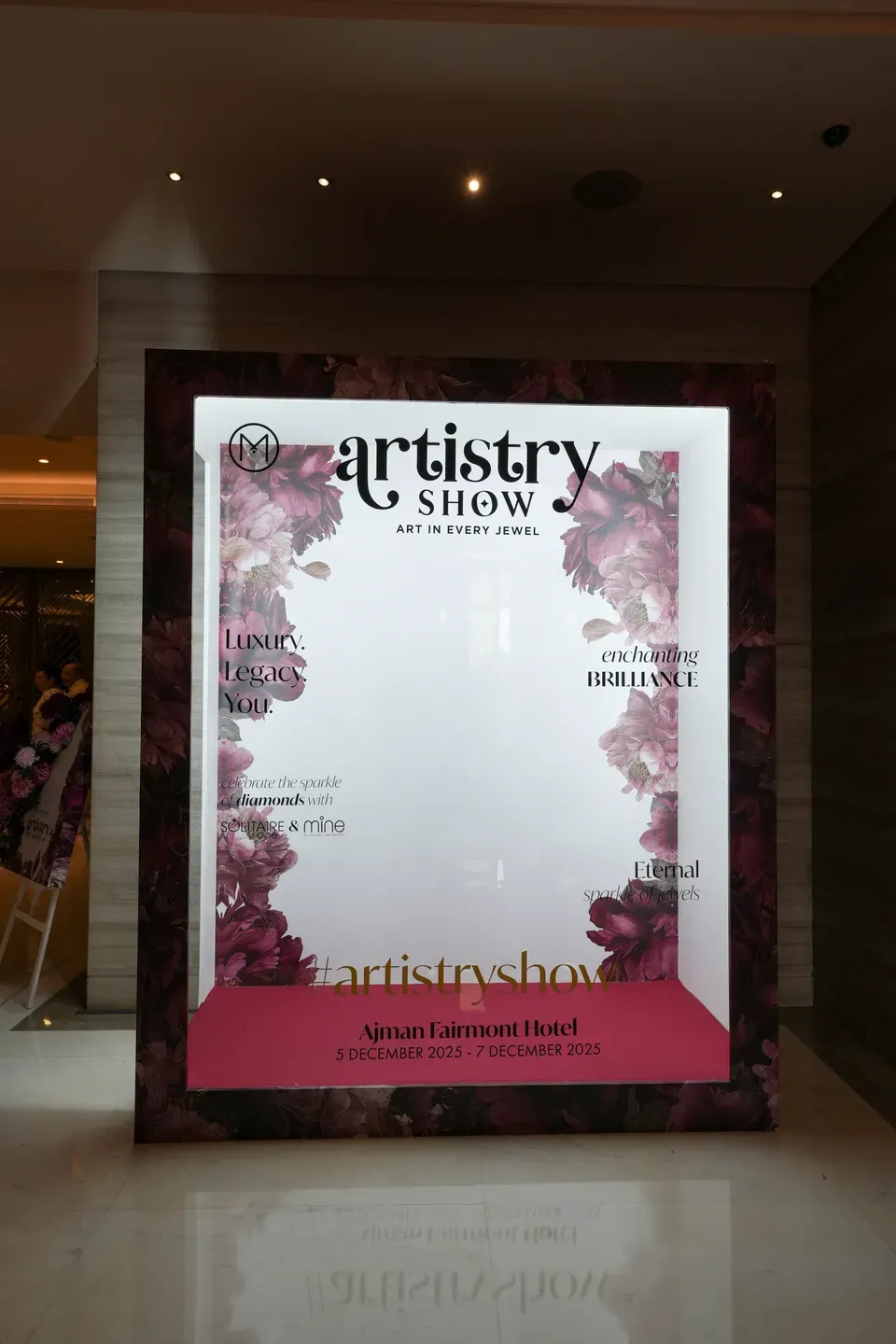 Illuminated event lightbox printed with the show name, dates and venue