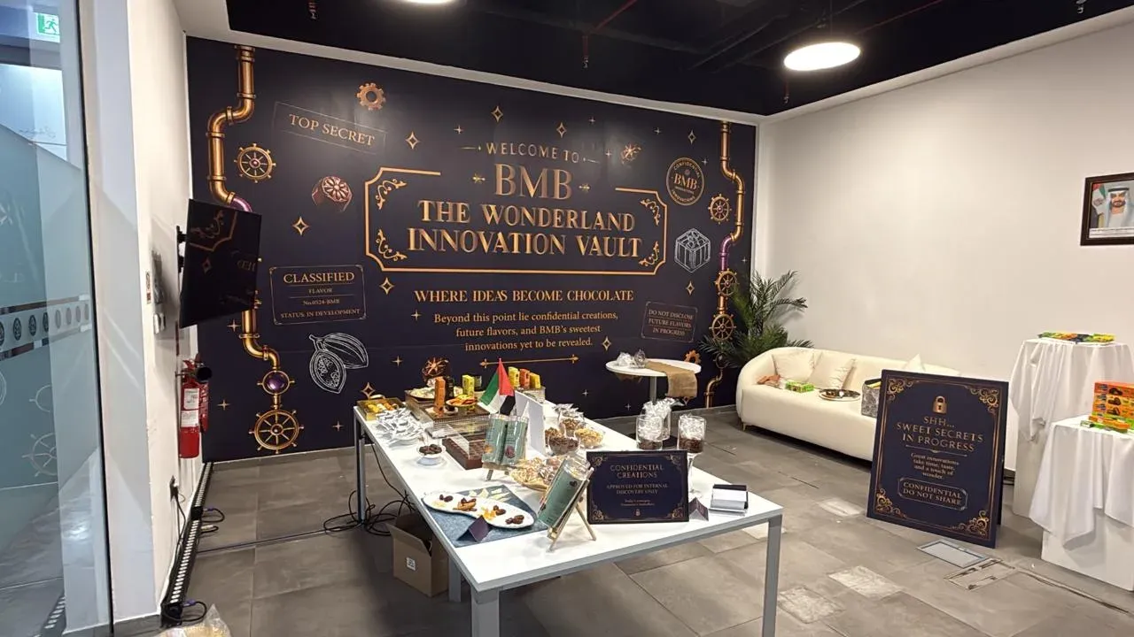 Navy and gold printed wall behind a tasting table laid with chocolate samples