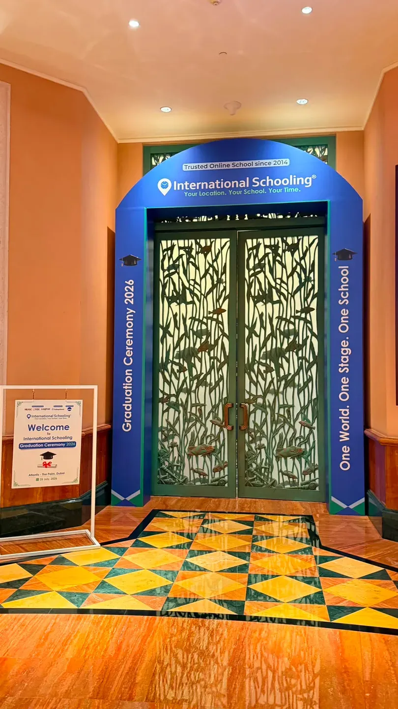Blue printed surround built around ornate ballroom doors with a welcome sign beside