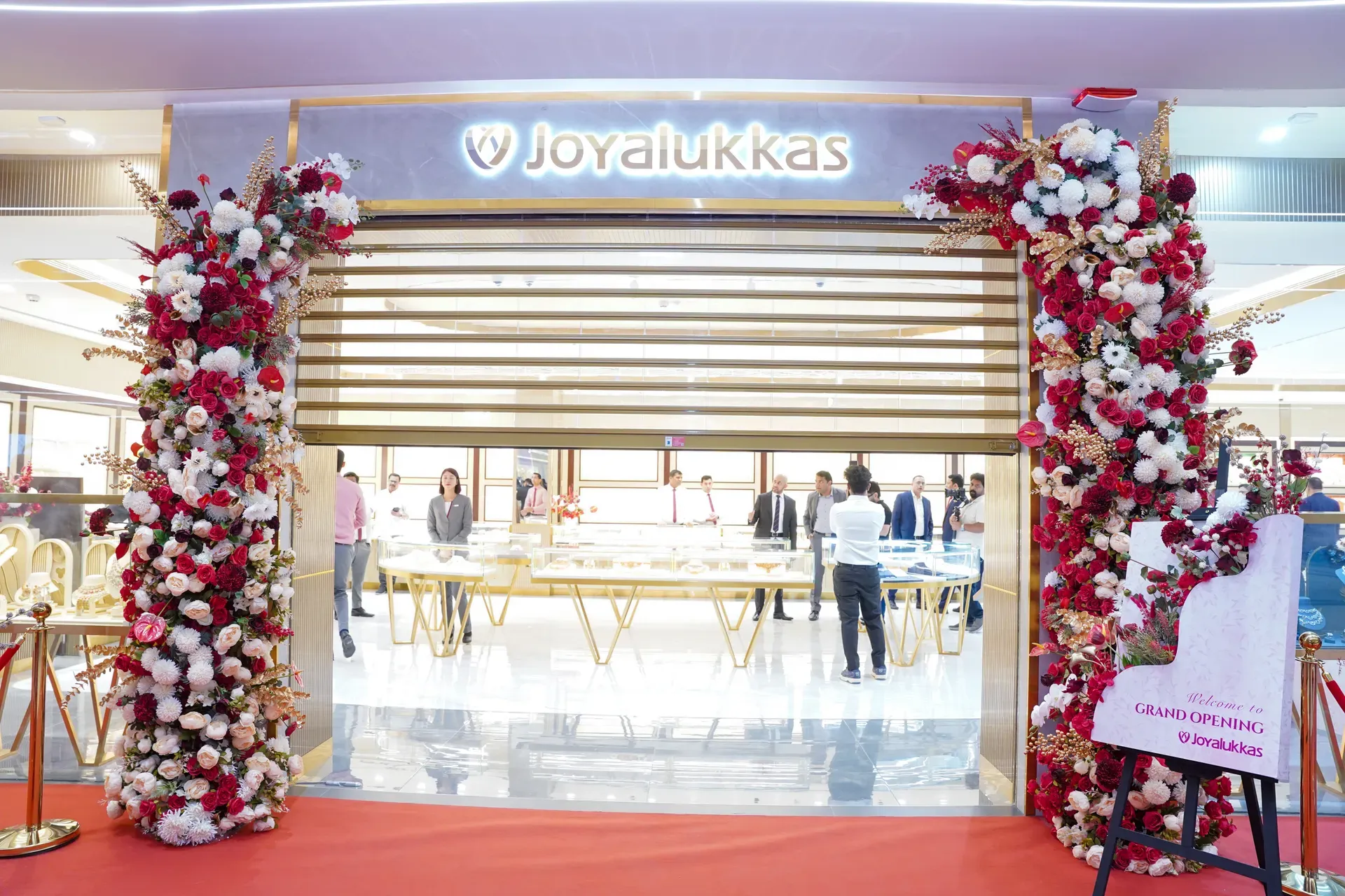 Jewellery storefront flanked by two tall red and white floral columns